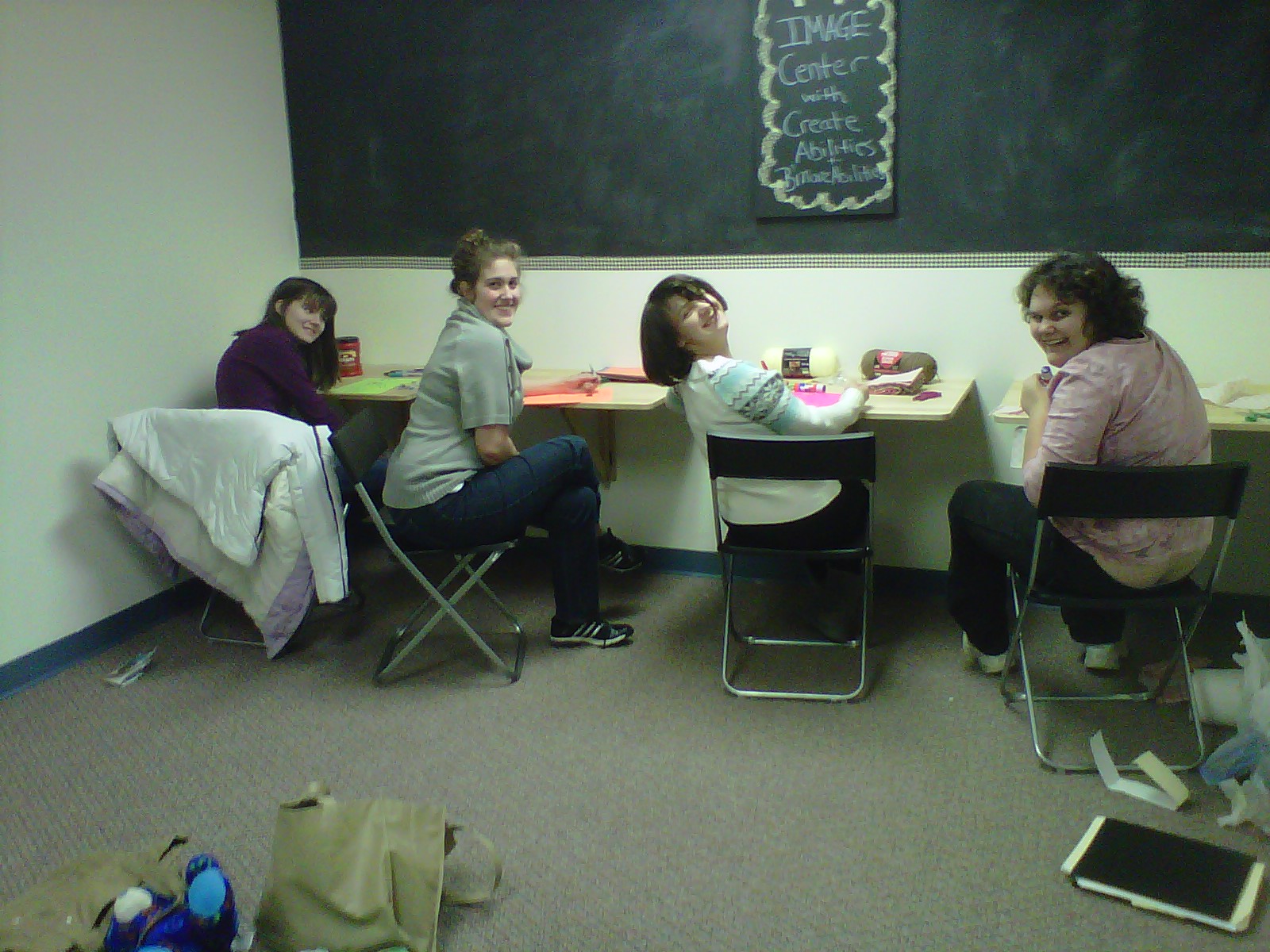 Four teen girls crafting self-portraits during a Girls Night Out session.