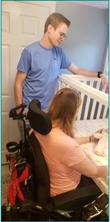 Mom in a wheelchair tucks baby safely into the crib