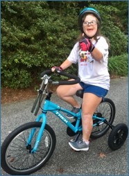 smiling kid on a modified bike