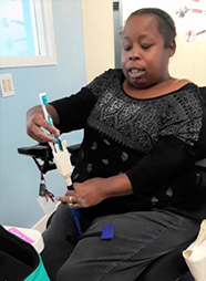 woman using modified toothbrush