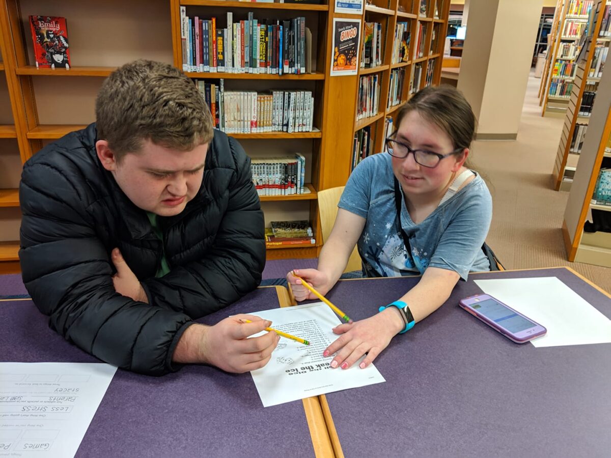 Peer Mentor Rebecca Parker assisting peer Patrick Hagen during a Connect program session.