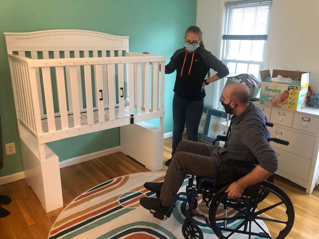 An elevated crib designed for a dad in a wheelchair to access his newborn.  