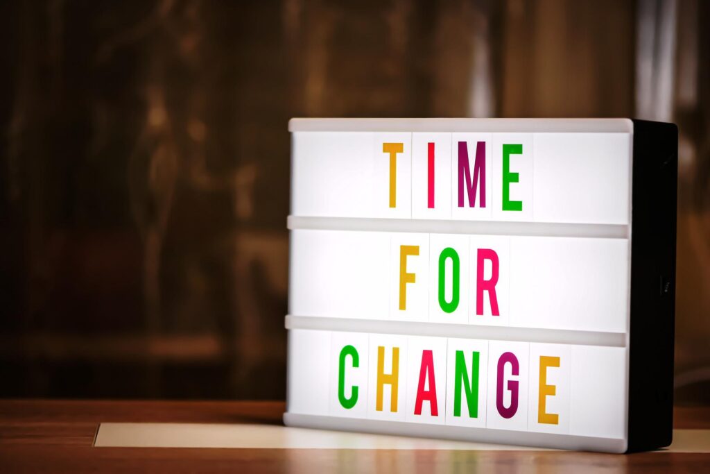 Letter board in a variety of bright colors reads "Time For Change". 