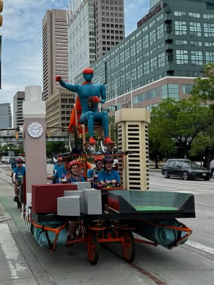 The IMAGE Man kinetic sculpture in all his glory parading down Pratt Street in the Baltimore Kinetic Sculpture Race.